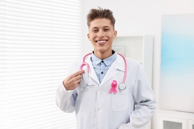 Photo of Mammologist with pink ribbon in hospital. Breast cancer awareness