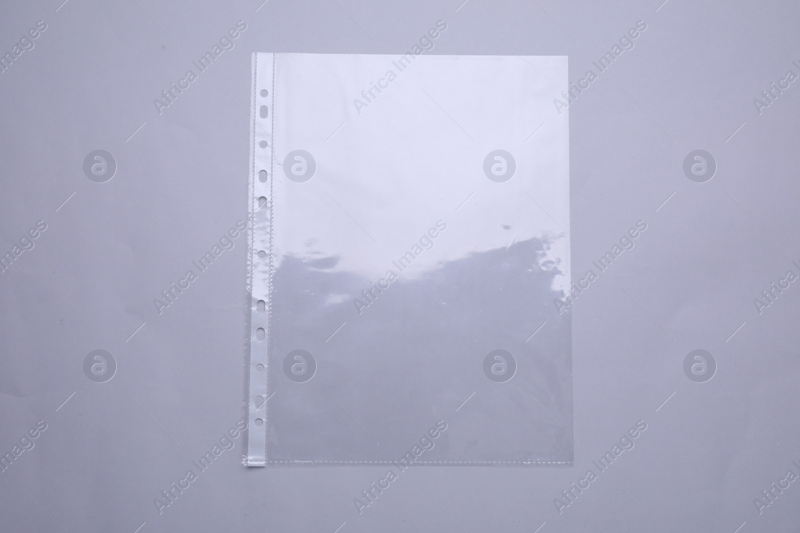 Photo of Empty punched pocket on light grey background, top view