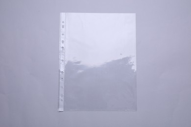 Photo of Empty punched pocket on light grey background, top view