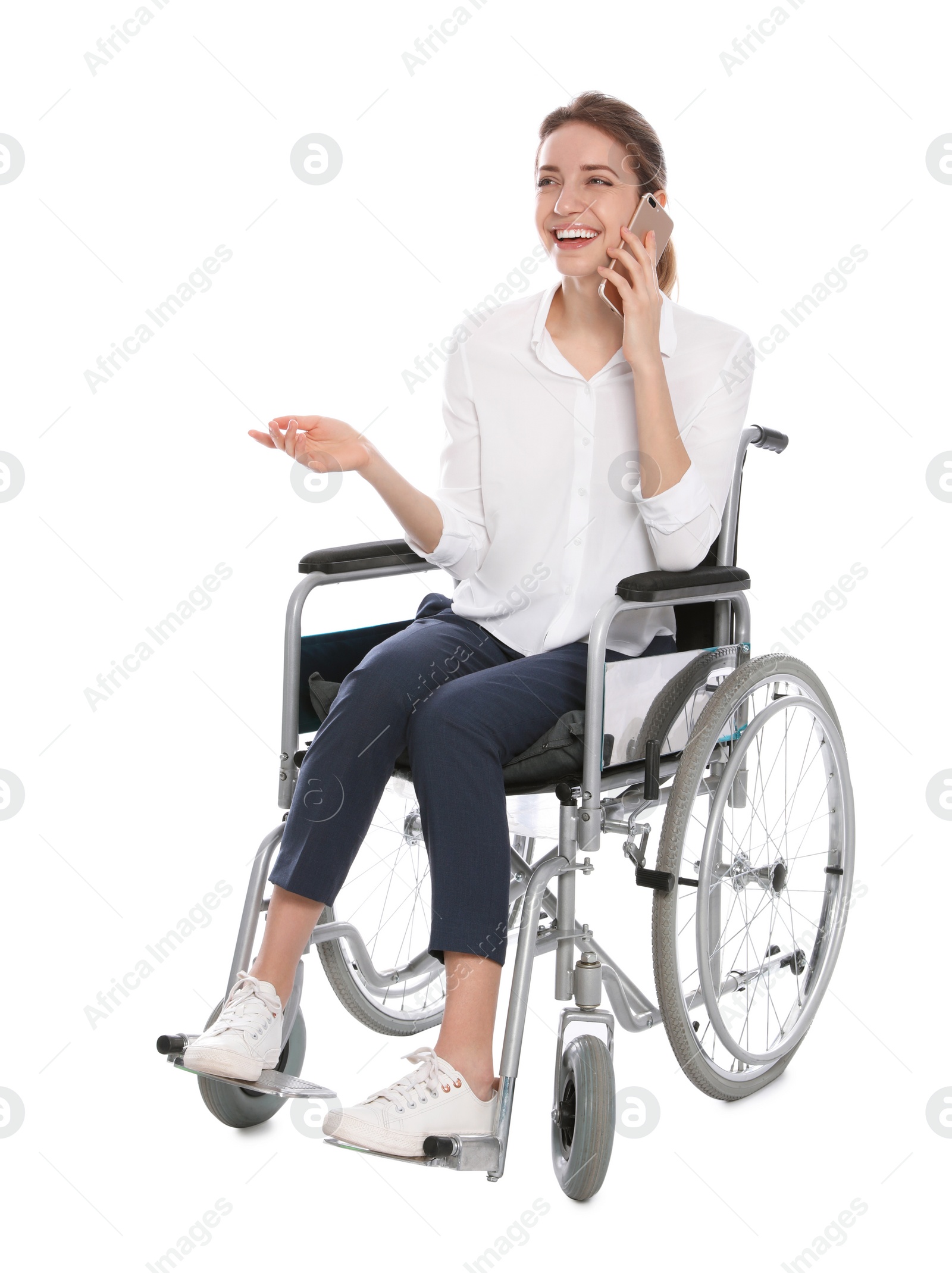 Photo of Young woman in wheelchair talking on mobile phone, white background