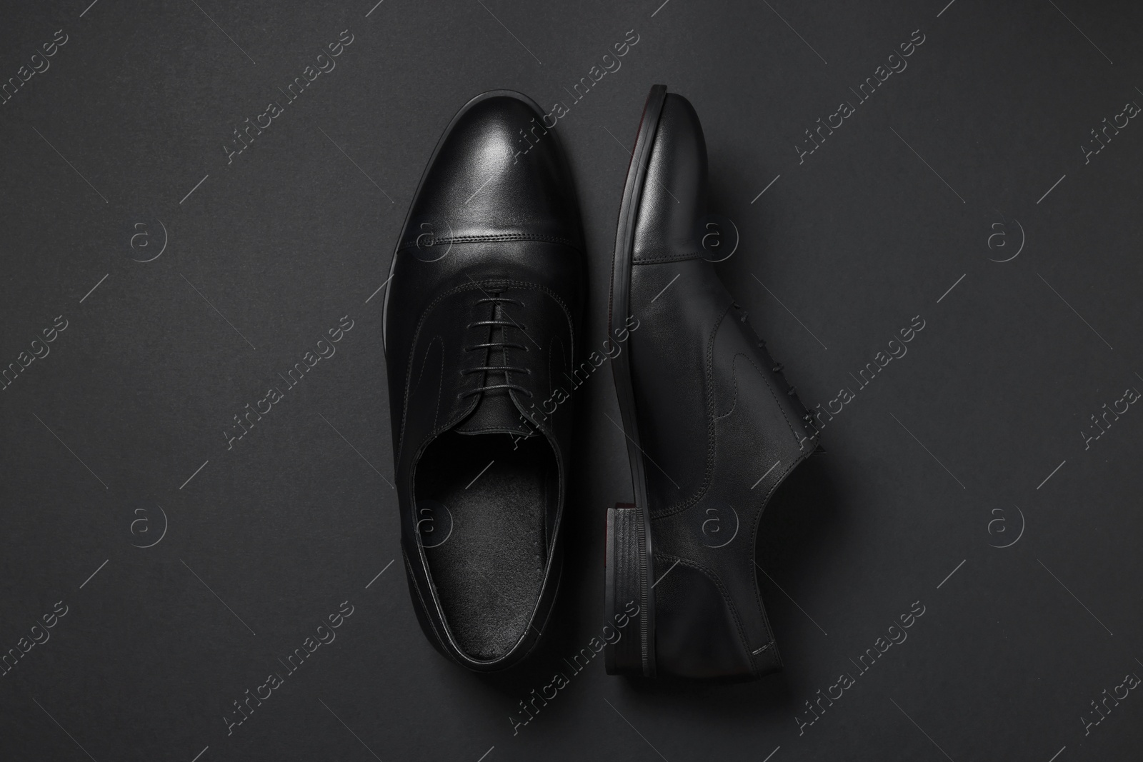 Photo of Pair of leather men shoes on black background, top view