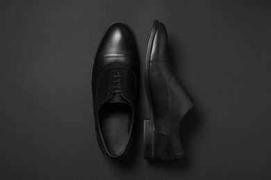 Photo of Pair of leather men shoes on black background, top view