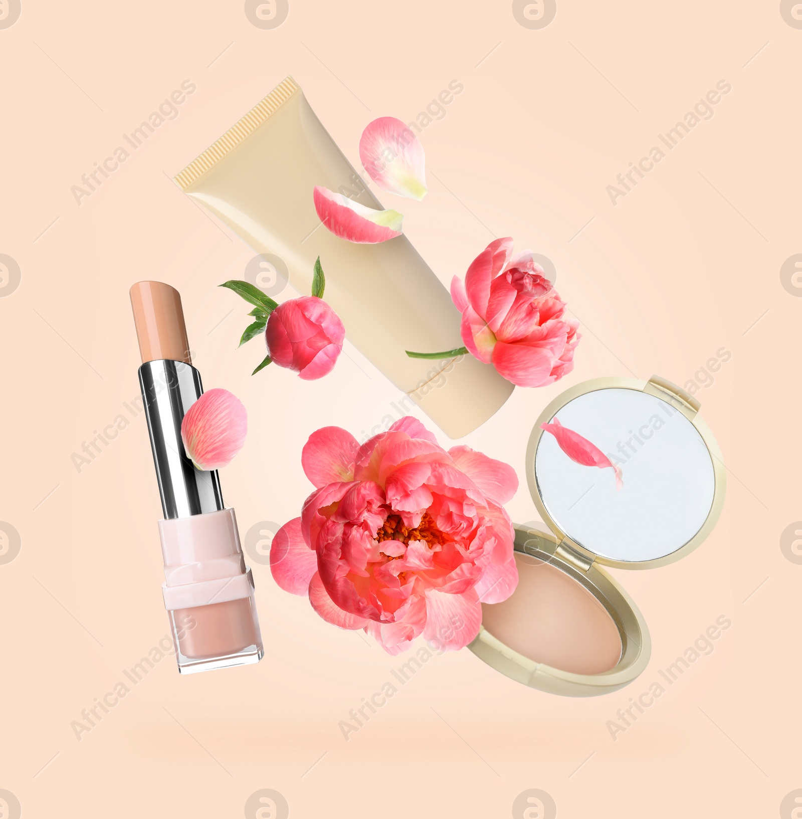 Image of Spring flowers and makeup products in air on beige background