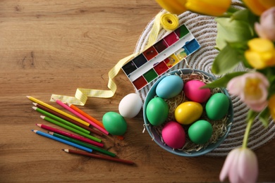 Photo of Flat lay composition with bright painted Easter eggs on wooden table