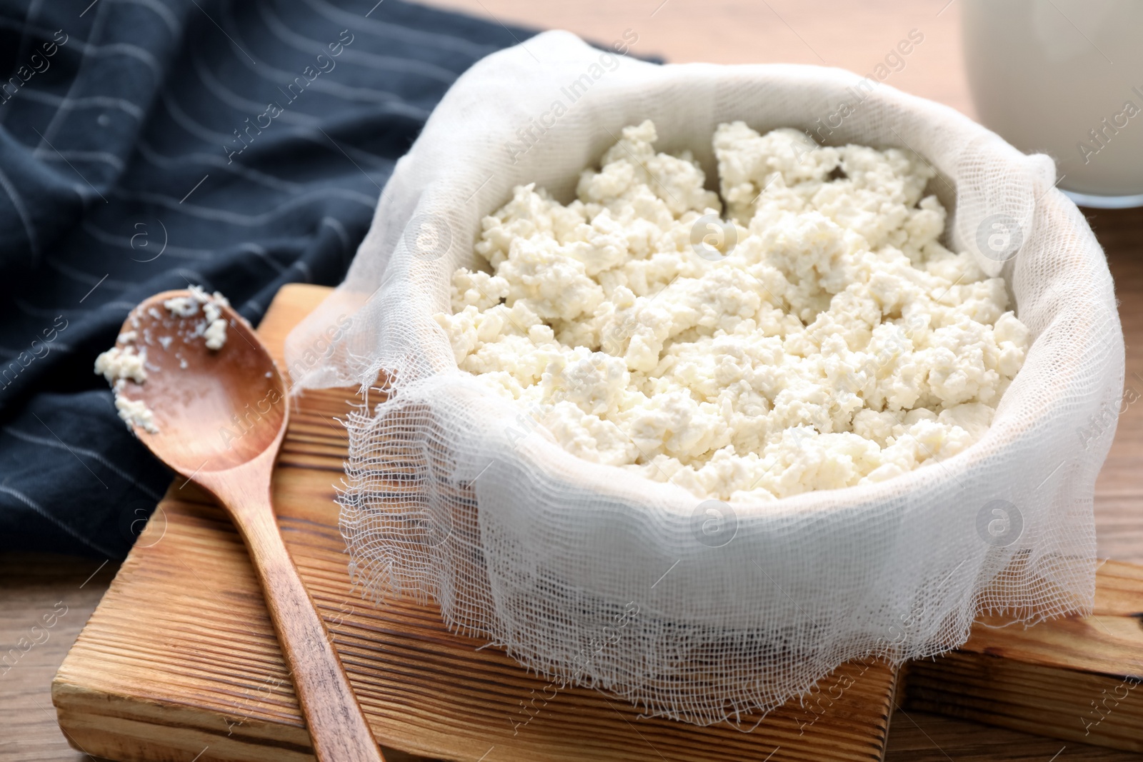 Photo of Delicious fresh cottage cheese on wooden table, closeup