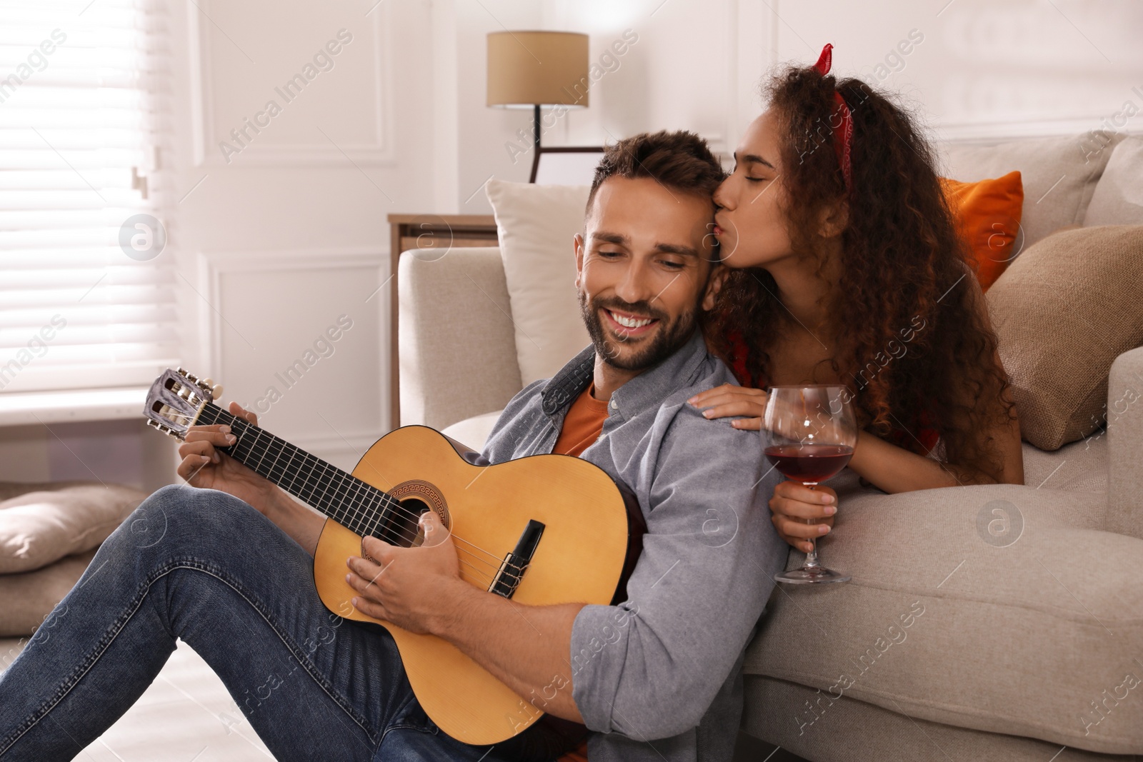 Photo of Lovely couple with guitar spending time together at home