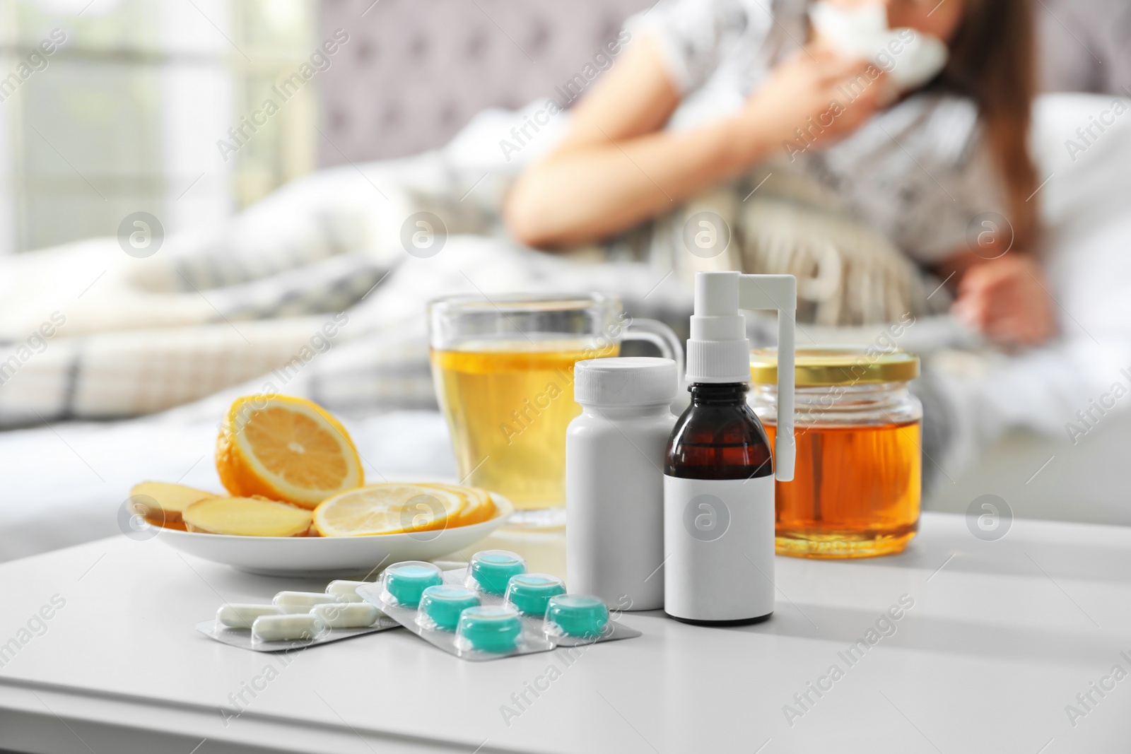 Photo of Cold remedies and sick woman on background indoors