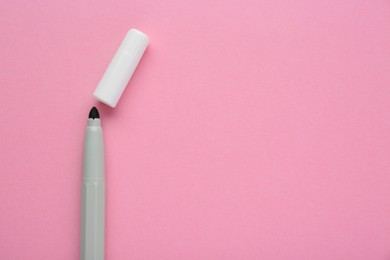 Photo of Bright grey marker and cap on light pink background, flat lay. Space for text