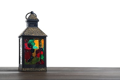 Photo of Decorative Arabic lantern on wooden table against white background