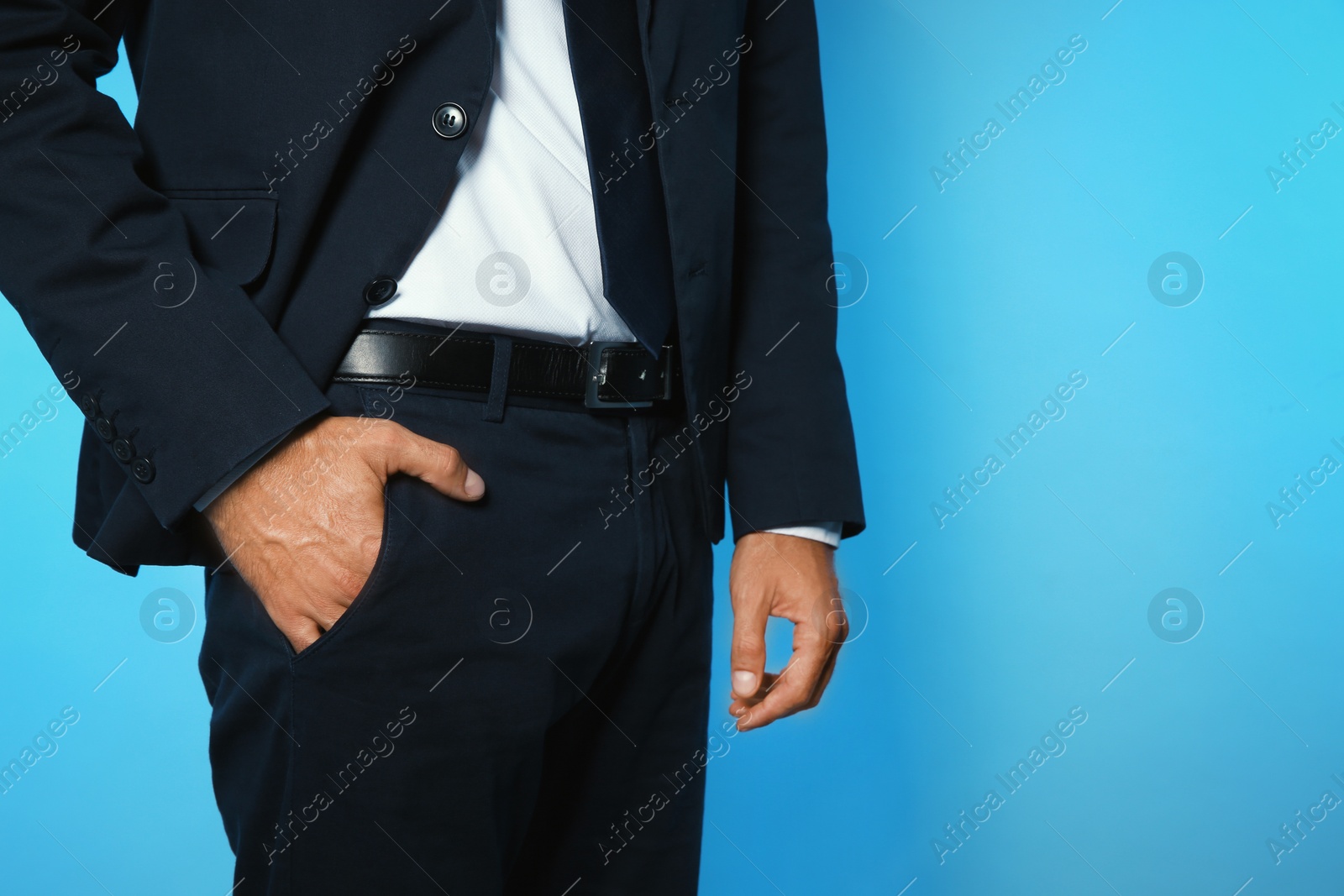 Photo of Businessman with hand in pocket on color background, closeup view. Space for text