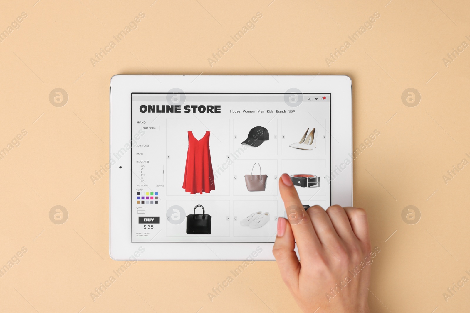 Photo of Woman with tablet shopping online on beige background, top view