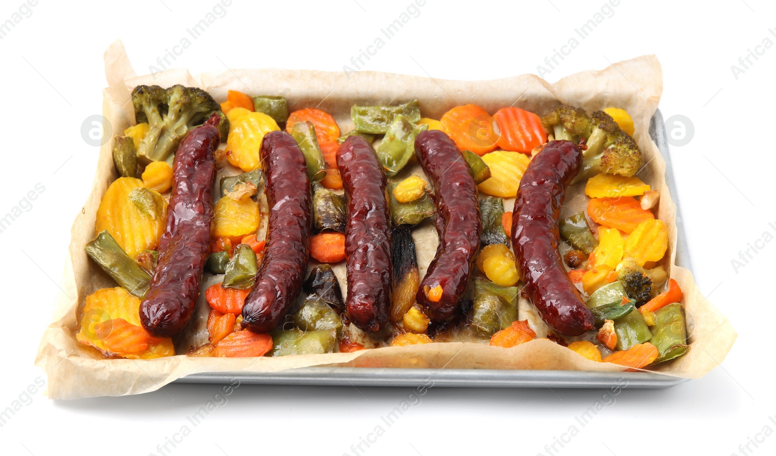 Photo of Baking tray with delicious smoked sausages and vegetables isolated on white