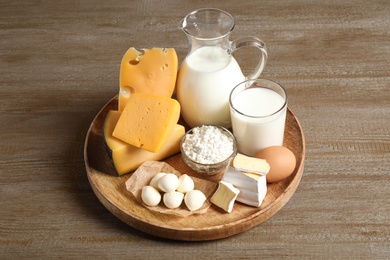Different delicious dairy products on wooden table