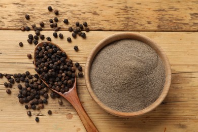 Aromatic spice. Ground and whole black pepper on wooden table, top view