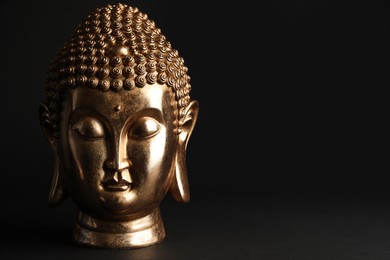 Photo of Beautiful golden Buddha sculpture on black background. Space for text