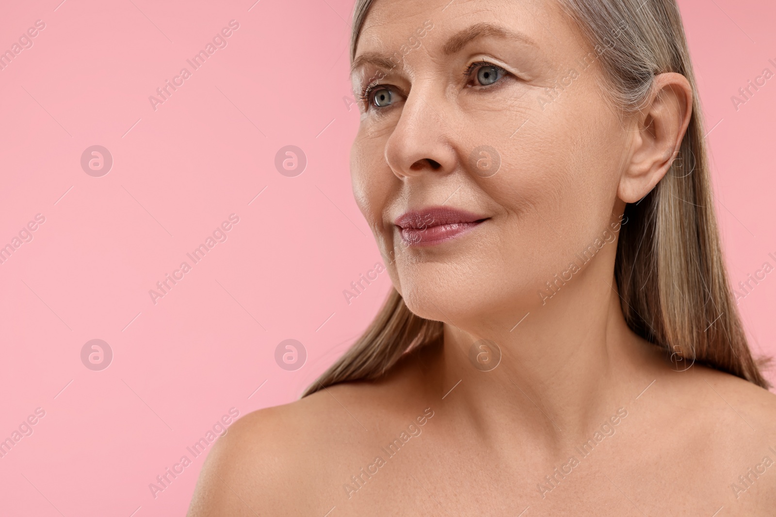 Photo of Beautiful woman with healthy skin on pink background, space for text