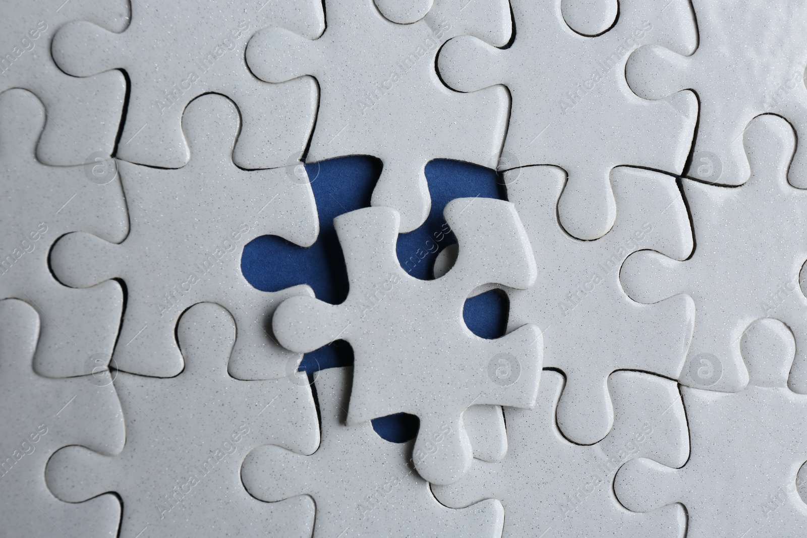 Photo of White puzzle on blue background, top view. Career promotion concept
