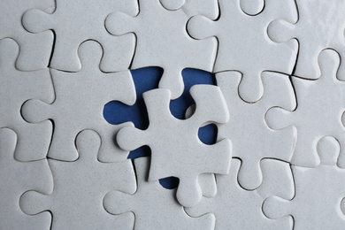 White puzzle on blue background, top view. Career promotion concept