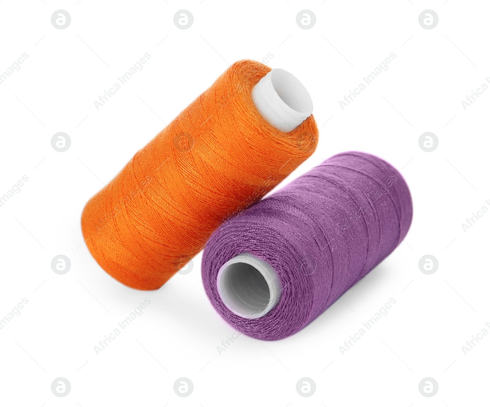 Photo of Different colorful sewing threads on white background