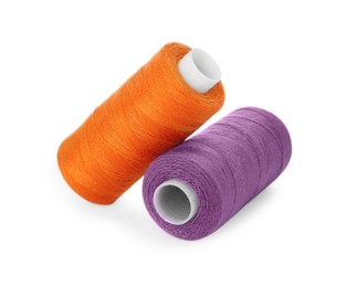 Photo of Different colorful sewing threads on white background