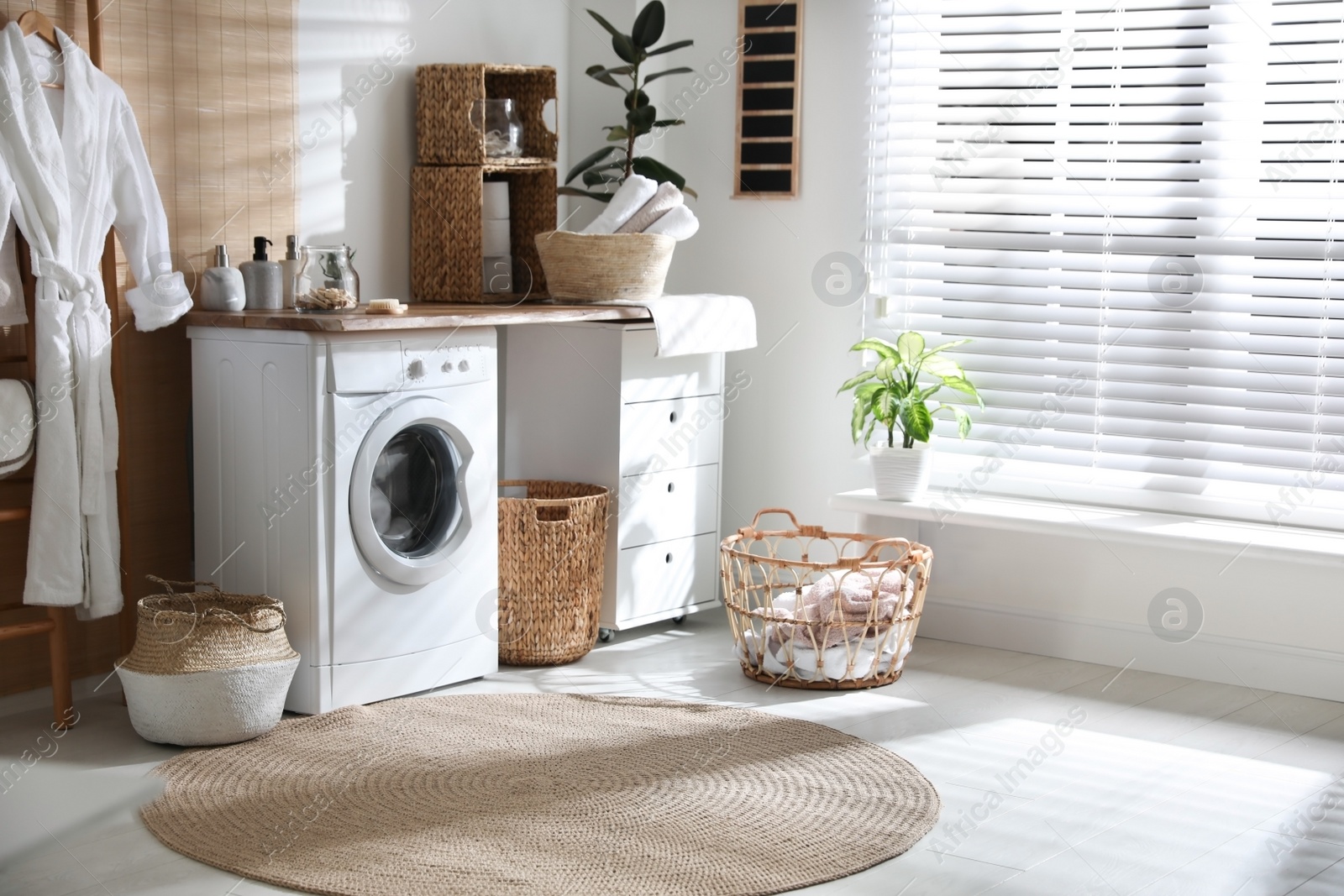 Photo of Stylish bathroom interior with modern washing machine