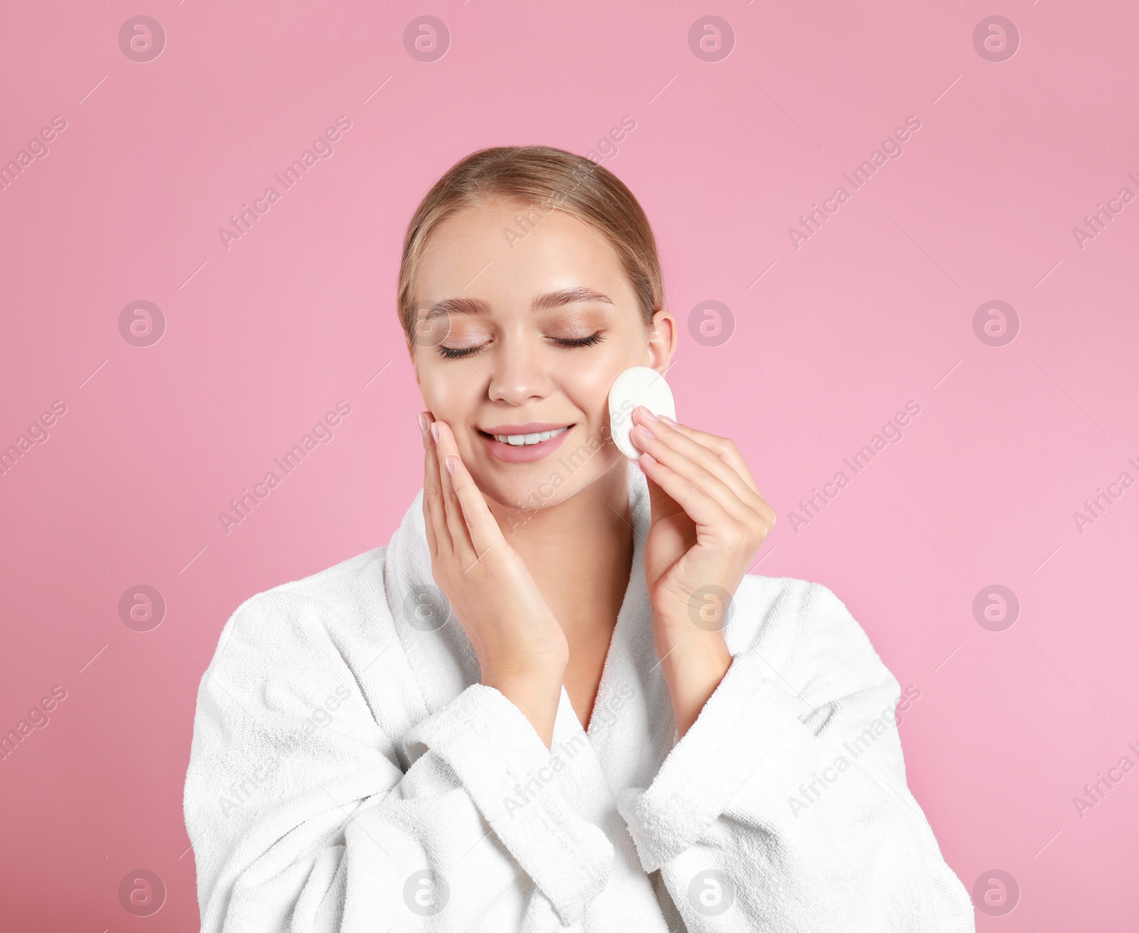 Photo of Beautiful young woman with cotton pad on pink background