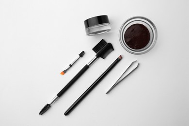 Photo of Flat lay composition with eyebrow henna and professional tools on white background