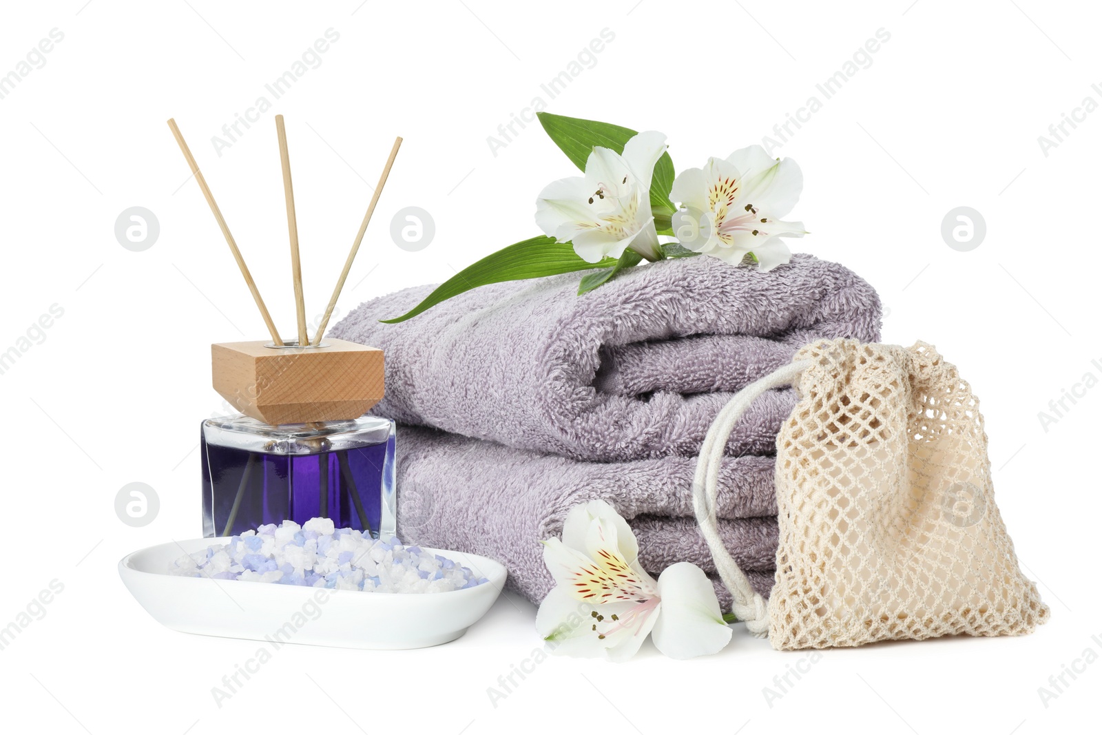 Photo of Spa composition. Towels, aromatherapy products, sea salt and beautiful flowers on white background