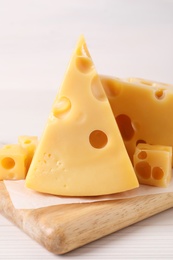 Photo of Tasty fresh cheese on white wooden table, closeup