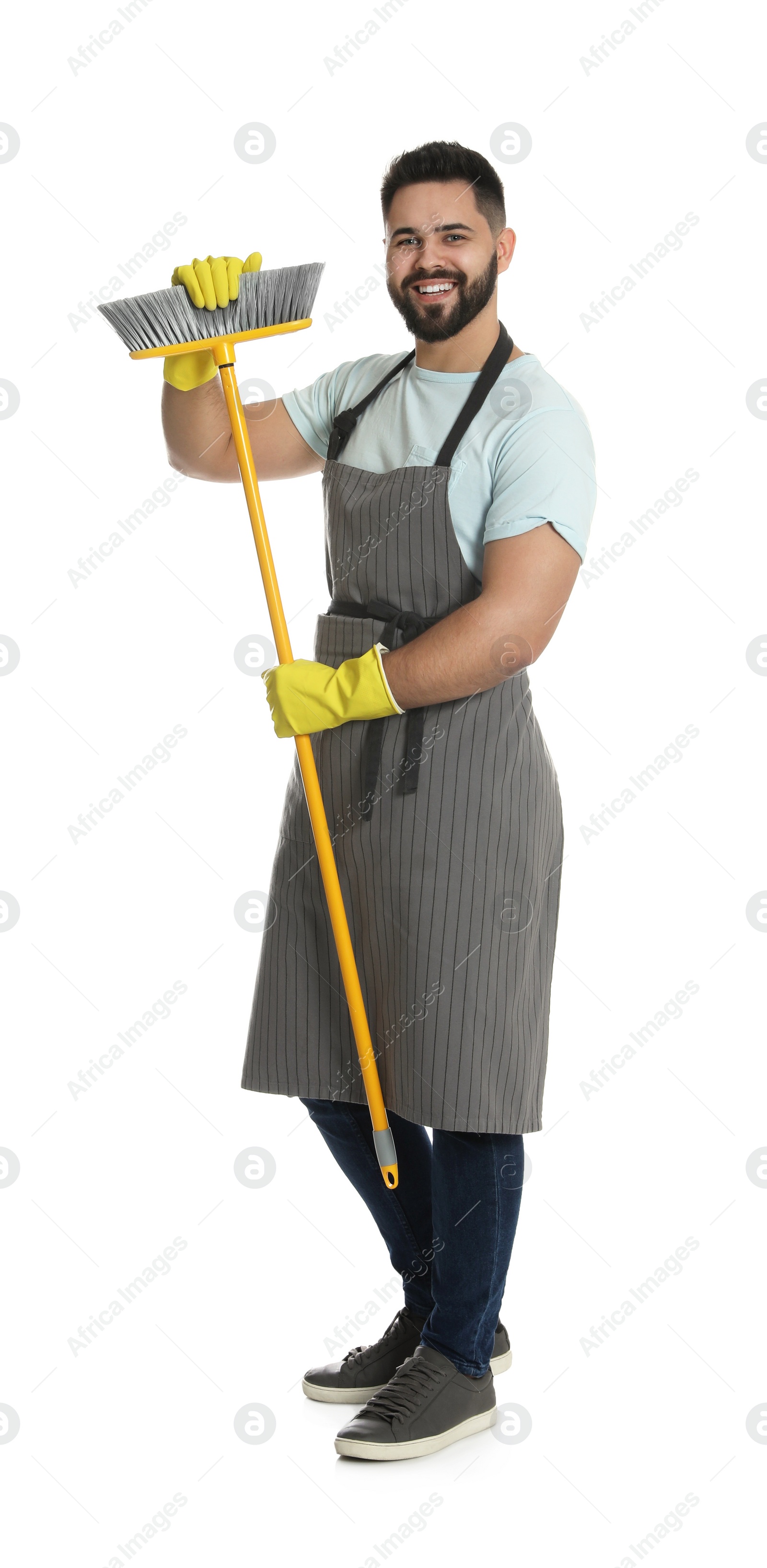 Photo of Young man with yellow broom on white background