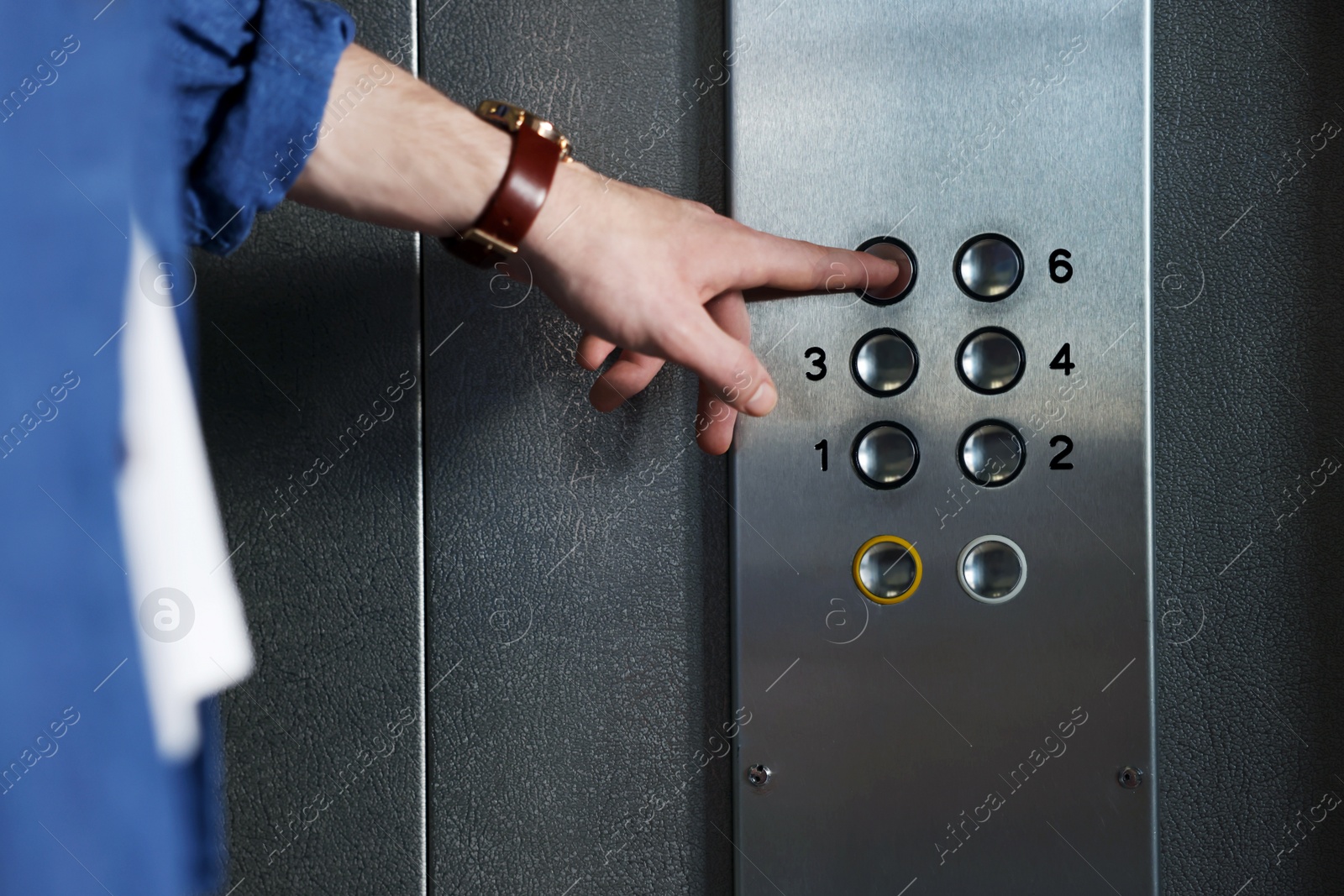 Photo of Man choosing floor in elevator, closeup view