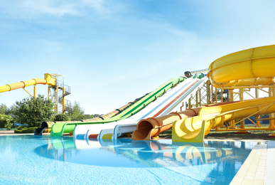 Photo of Different colorful slides in water park on sunny day