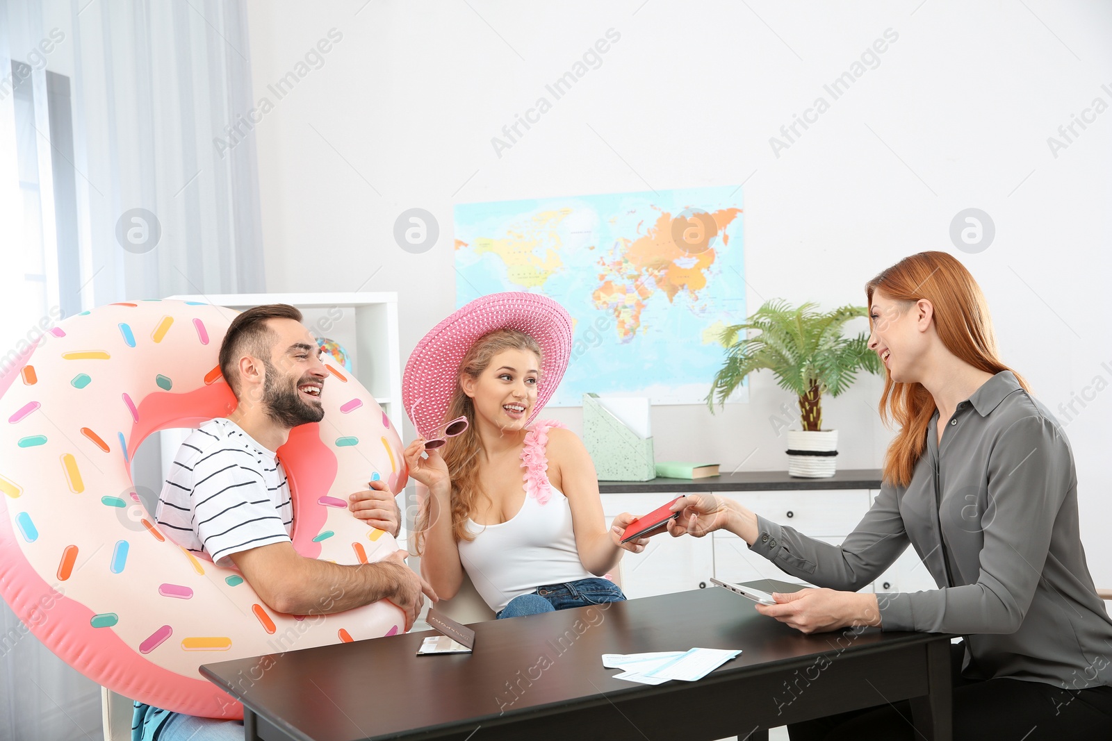 Photo of Beautiful young couple visiting travel agency office