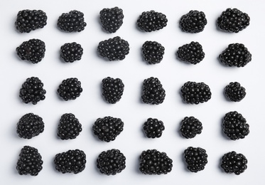 Flat lay composition with ripe blackberries on white background