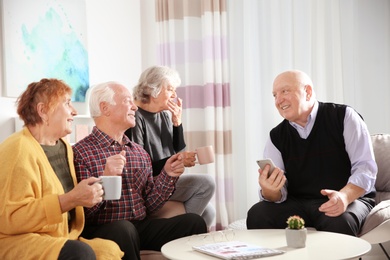 Elderly people spending time together in living room