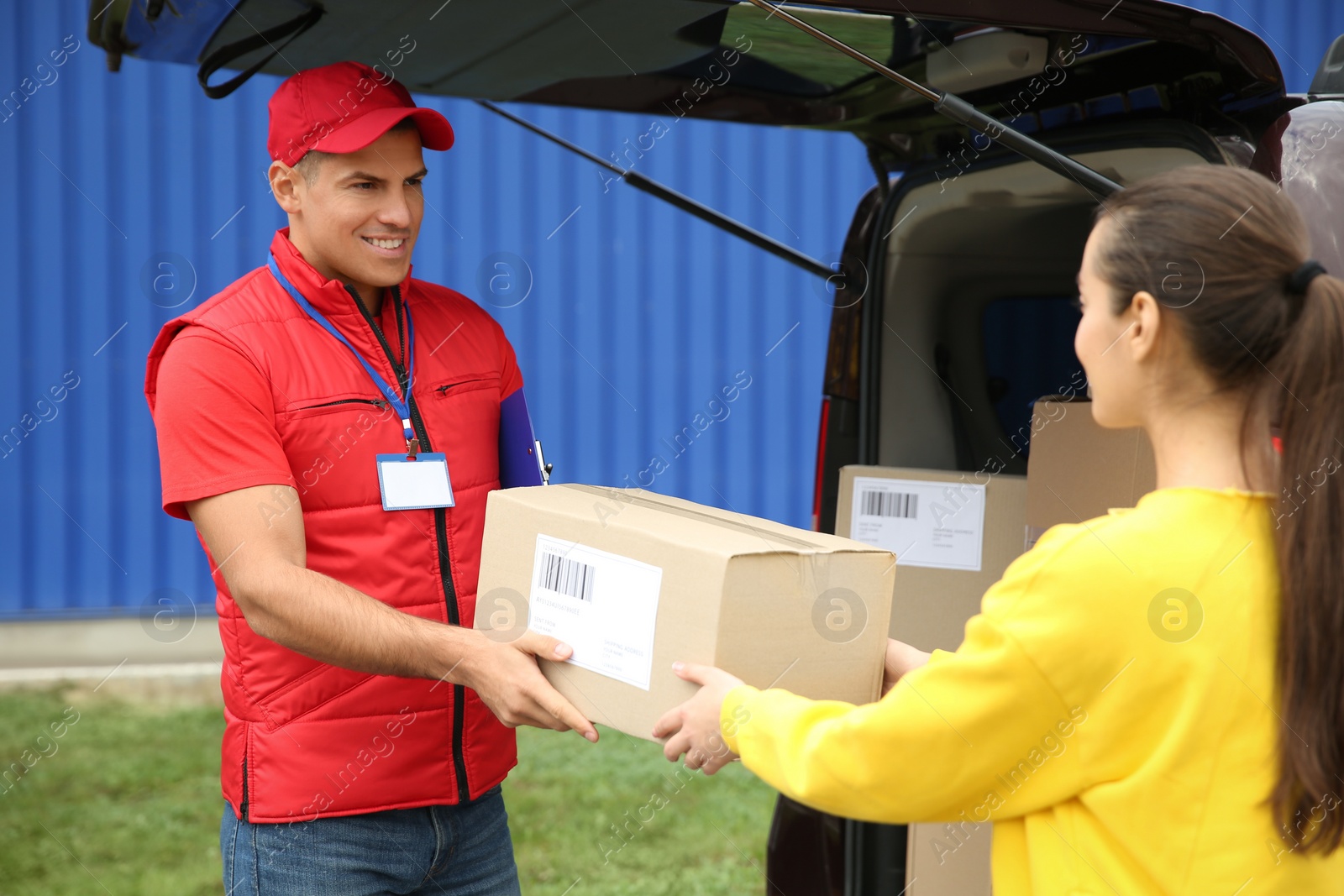 Photo of Courier giving package to customer on street