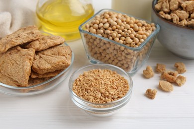 Different natural soy products on white wooden table