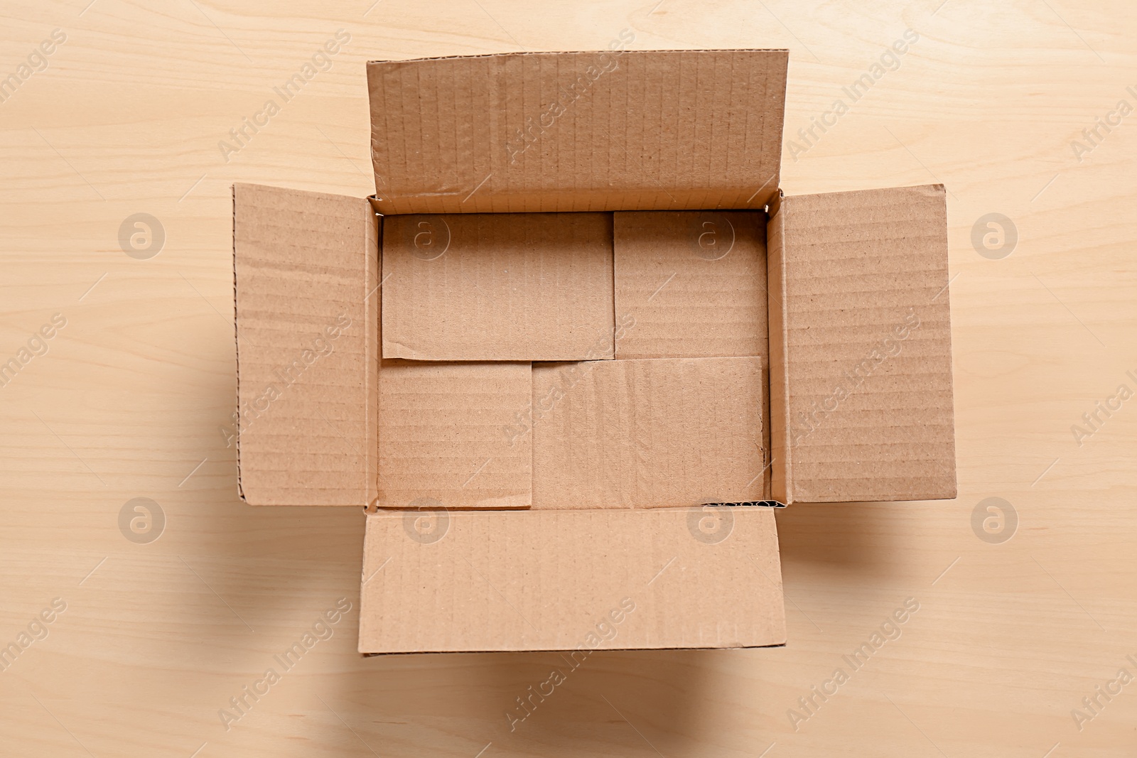 Photo of Cardboard box on wooden background