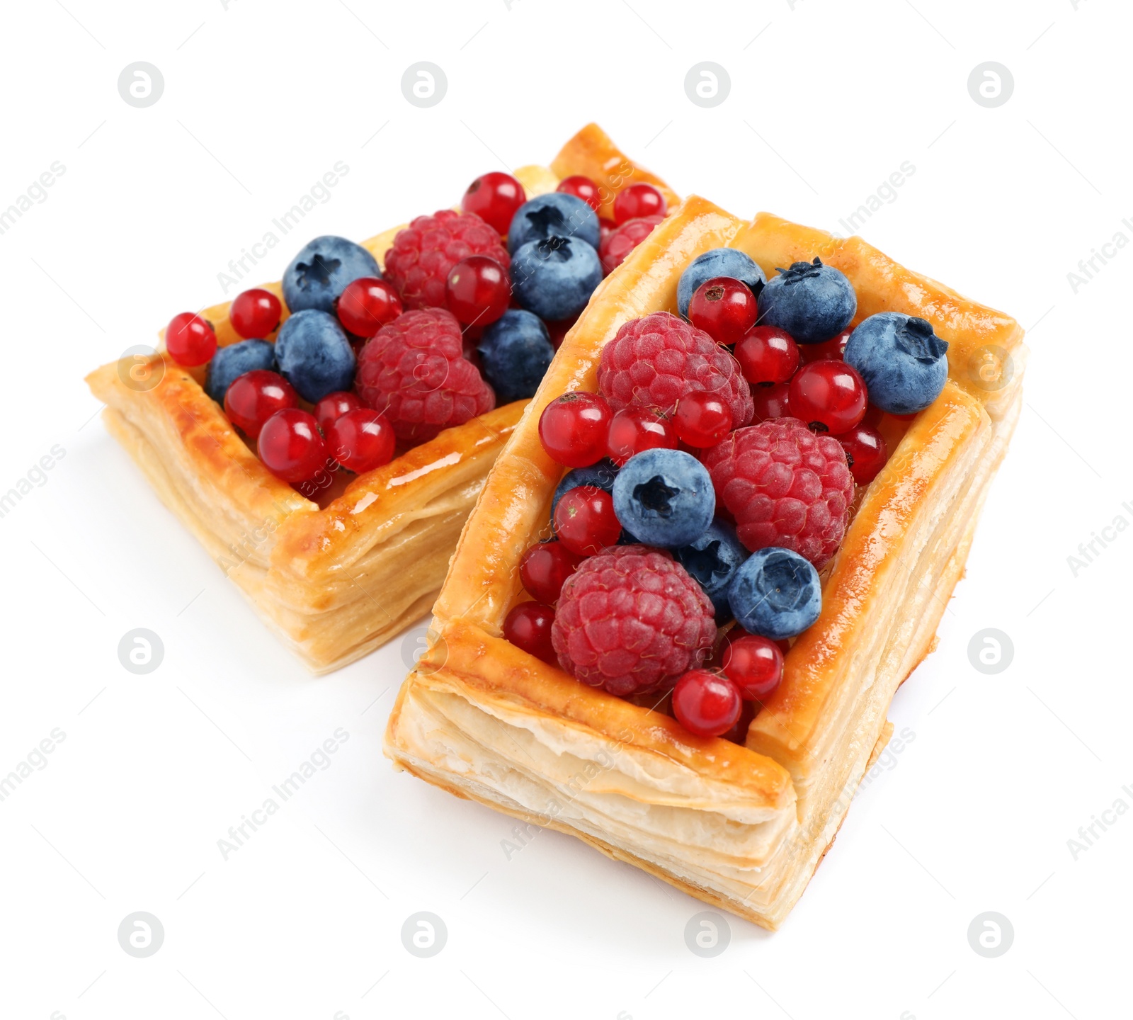 Photo of Fresh delicious puff pastry with sweet berries on white background