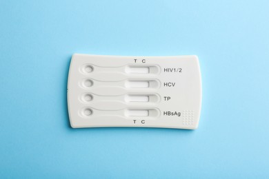 Photo of Disposable multi-infection express test on light blue background, top view