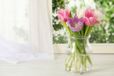 Beautiful fresh tulips on window sill indoors. Spring flowers