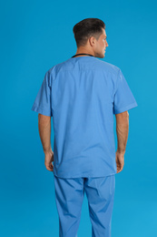 Doctor in clean uniform on blue background