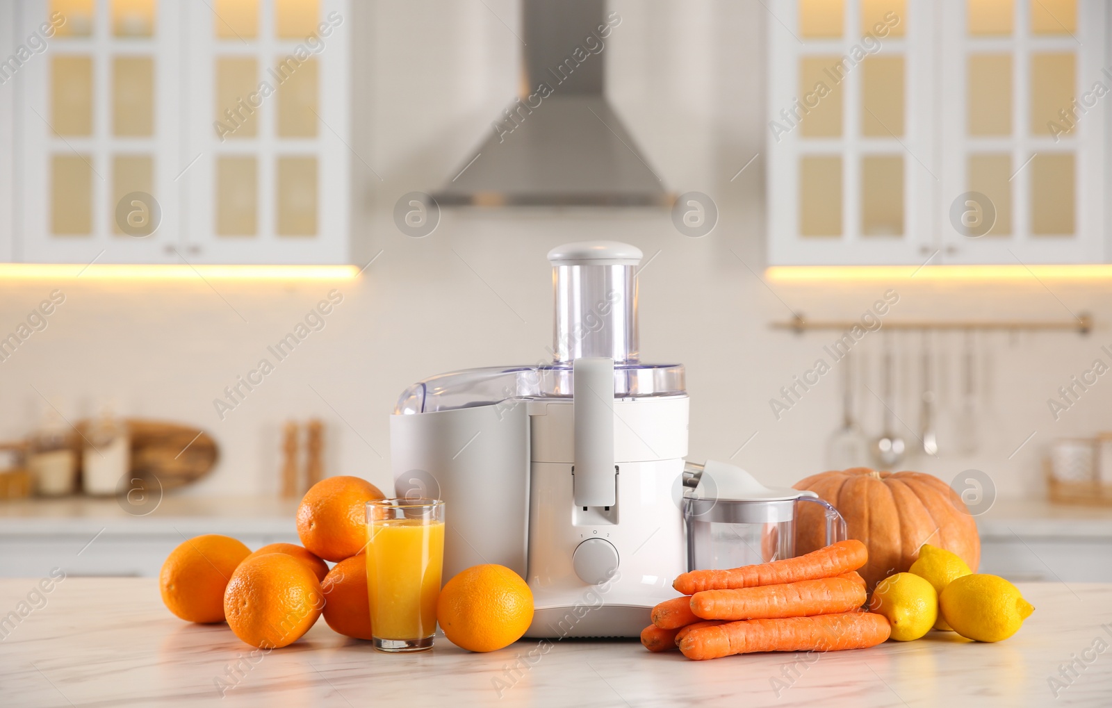 Photo of Modern juicer, fresh vegetables and fruits on table in kitchen