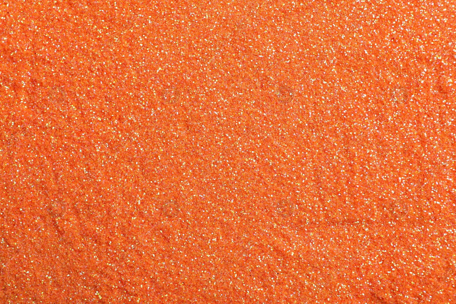 Photo of Shiny orange glitter as background, top view