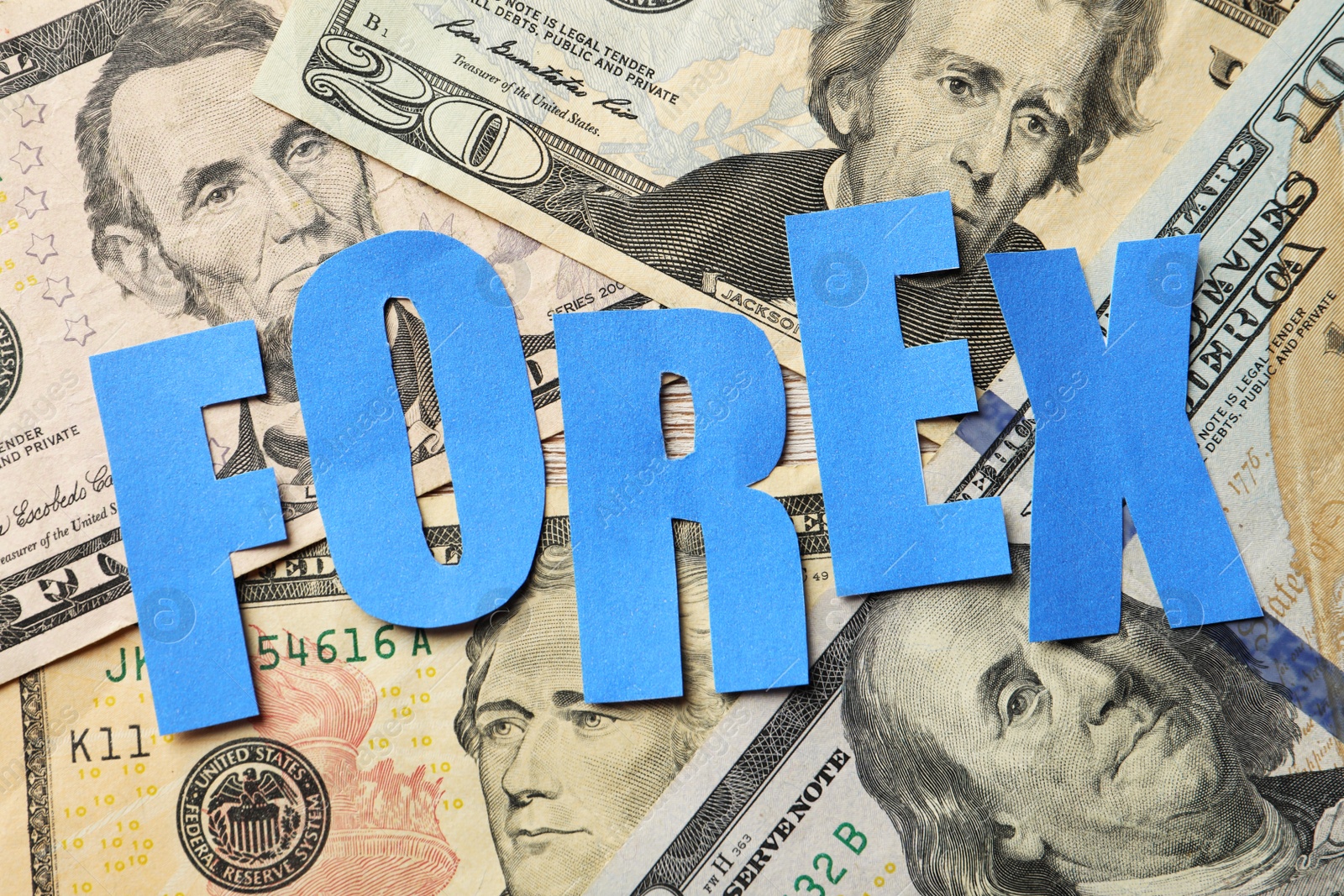 Photo of Word Forex made of blue letters on dollar banknotes, flat lay