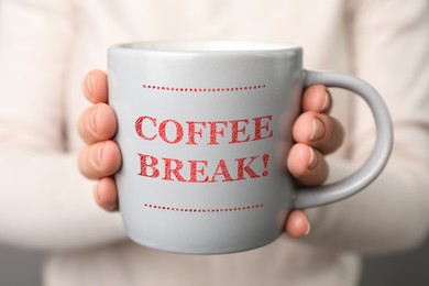 Woman holding mug with inscription Coffee Break, closeup