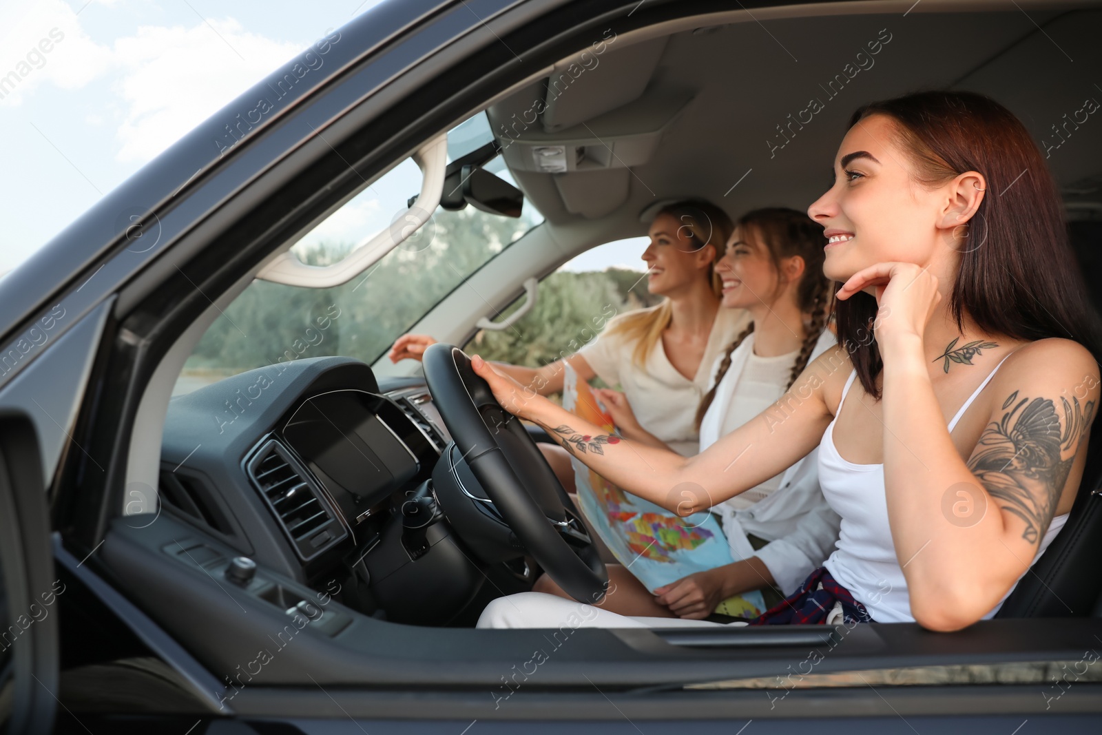 Photo of Happy friends together in car on road trip