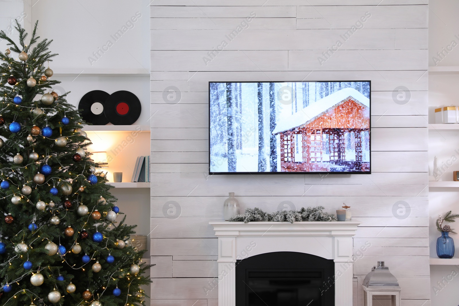 Photo of Stylish living room interior with modern TV and Christmas tree