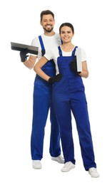 Photo of Professional workers in uniform with putty knives on white background