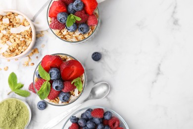 Tasty oatmeal with smoothie, berries and mint on white marble table, flat lay. Space for text. Healthy breakfast